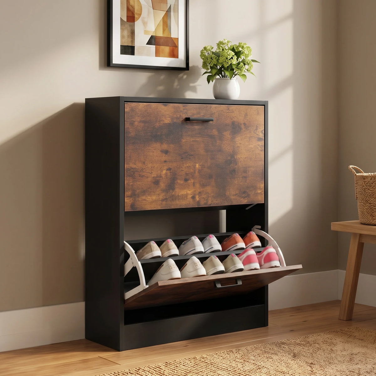 [White] two-tier shoe organizer with pull-out shoe racks, shown in a styled room setting with a beige wall, wooden floor, and a small plant on top.